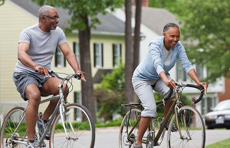 Two people riding their bikes